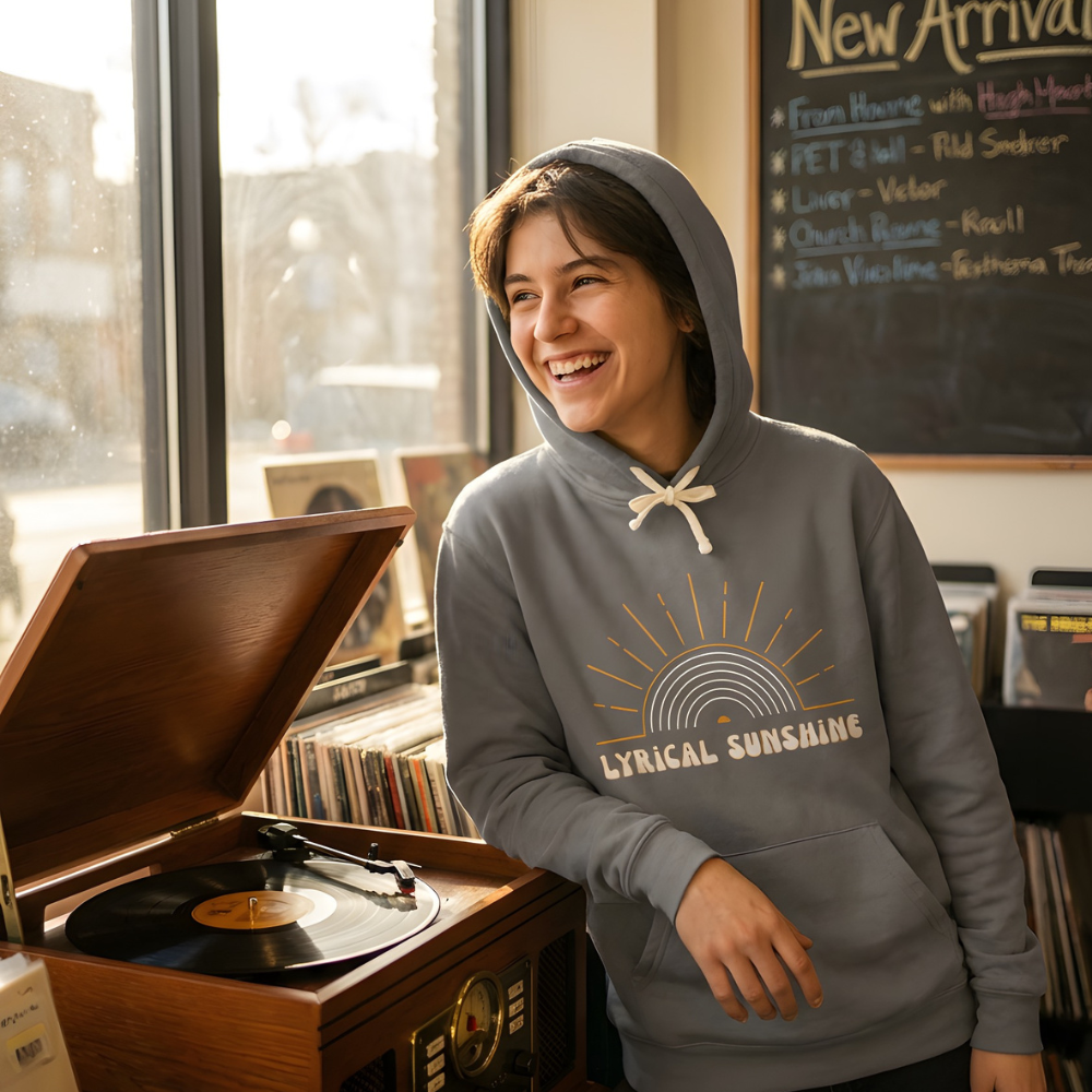 Person wearing a gray hoodie with 'Lyrical Sunshines' design in a record store.