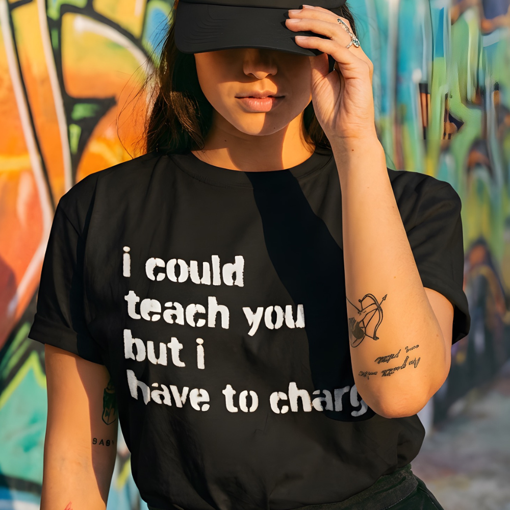 Person wearing a black cap and t-shirt with text, standing against a colorful graffiti wall.