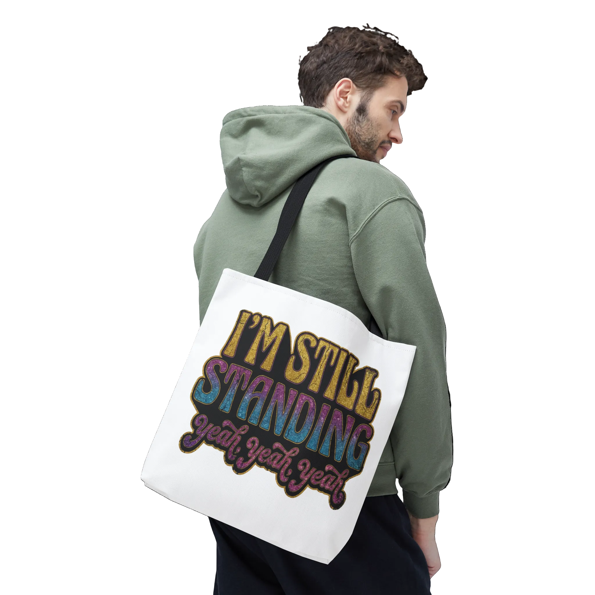 Person wearing a green hoodie holding a tote bag with colorful text.