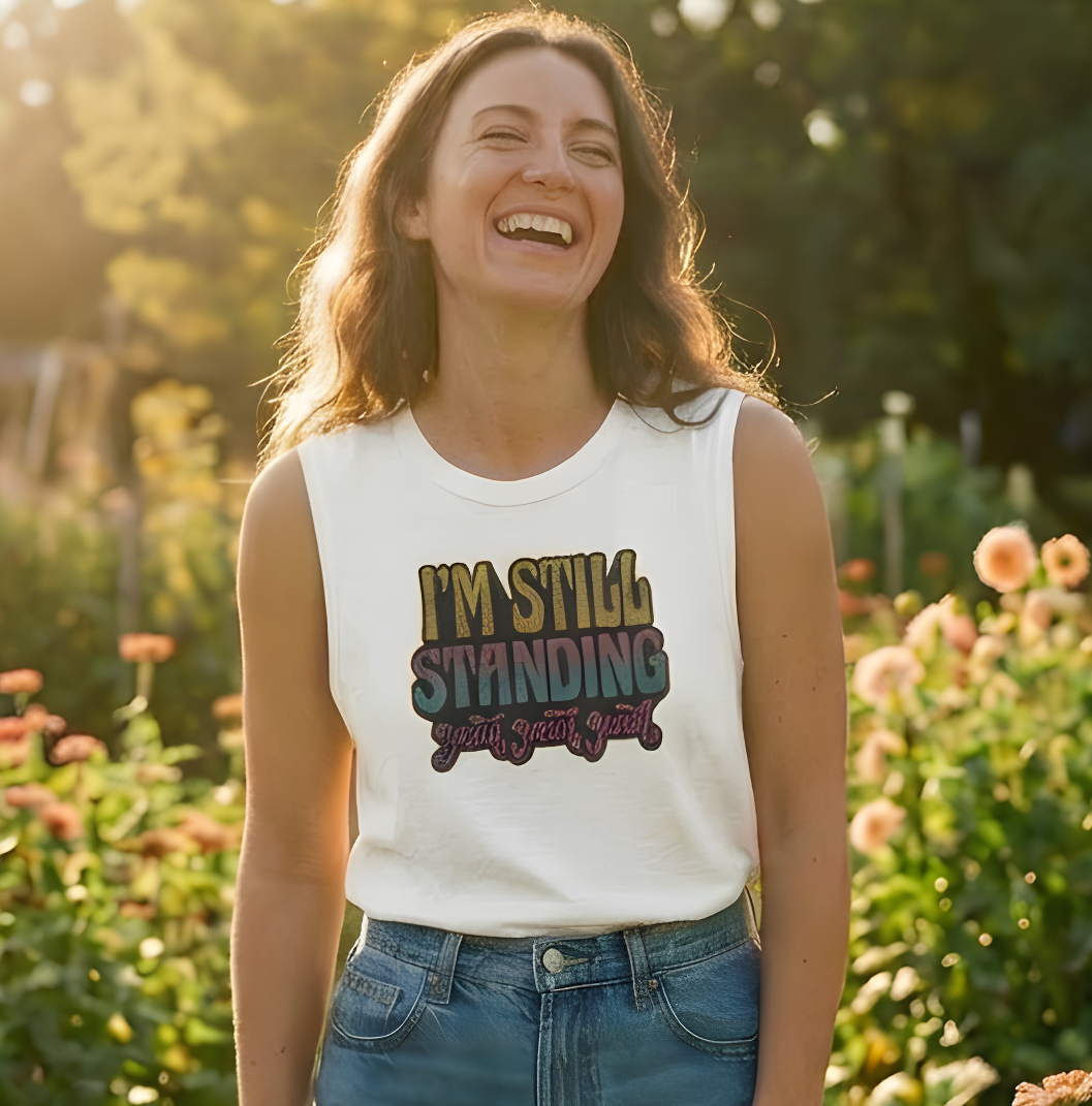 Woman standing in a field of flowers wearing a white tank top with text and denim shorts, with 'Lyrical Sunshine' logo above.