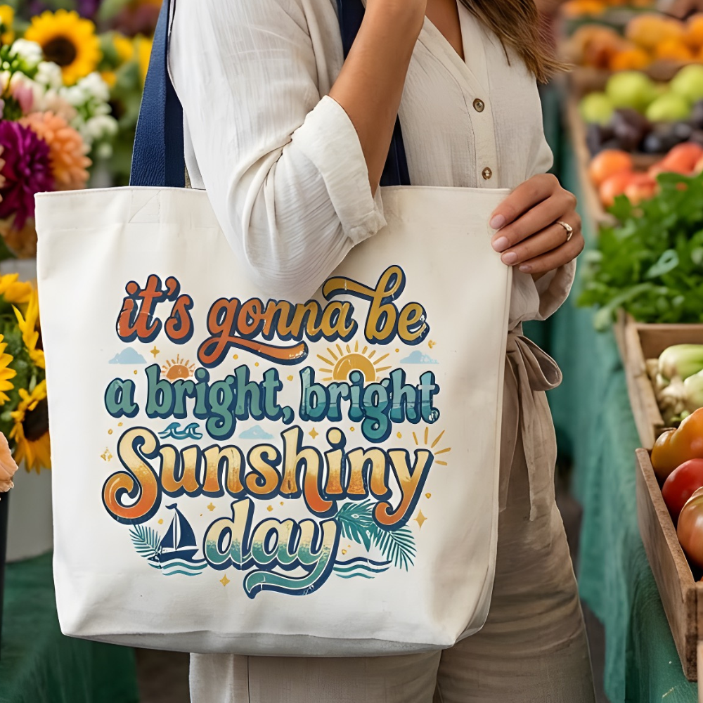 Woman holding a tote bag with a motivational quote at a farmers market.
