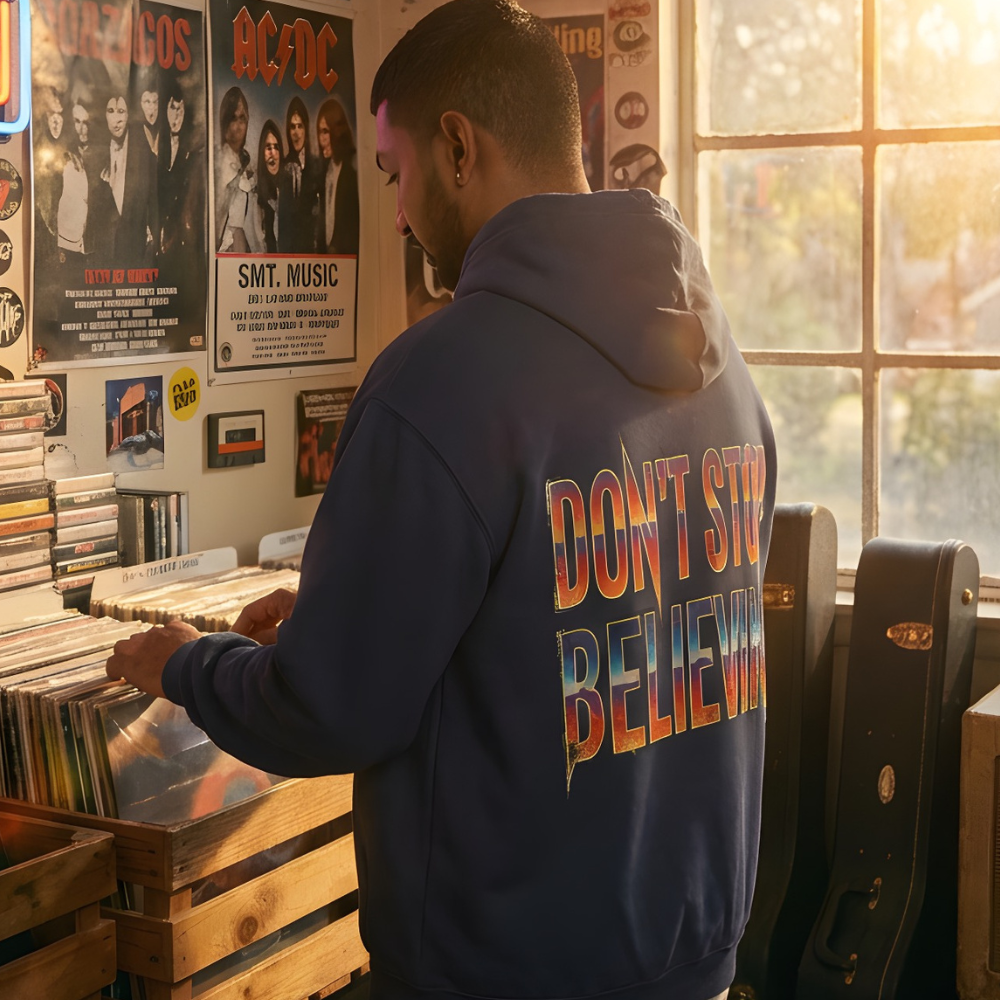 Man wearing a hoodie with 'Don't Stop Believing' text in a record store.