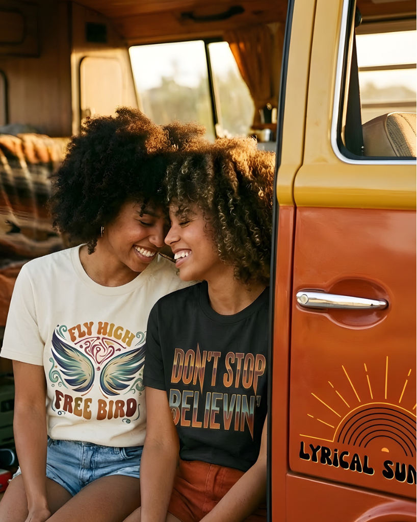 Two people sitting inside a vintage van with a sunset in the background