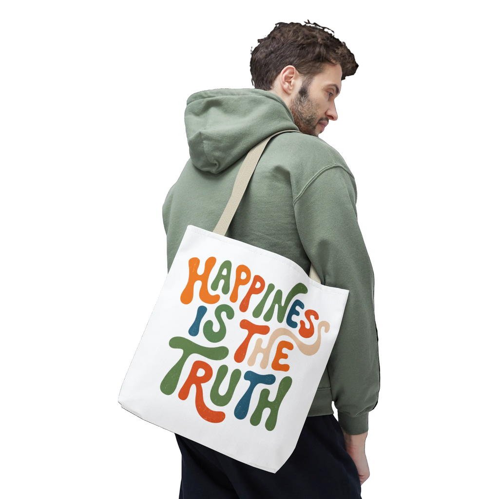 Man carrying a tote bag with 'Happiness is the Truth' text on a white background