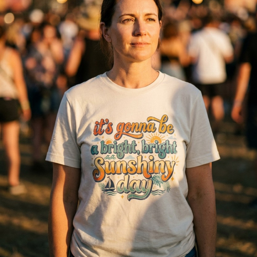 Woman wearing a t-shirt with a motivational quote at an outdoor event.