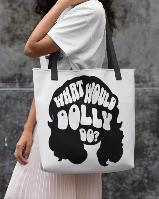 Woman holding a tote bag with 'What Would Dolly Do?' text and graphic.
