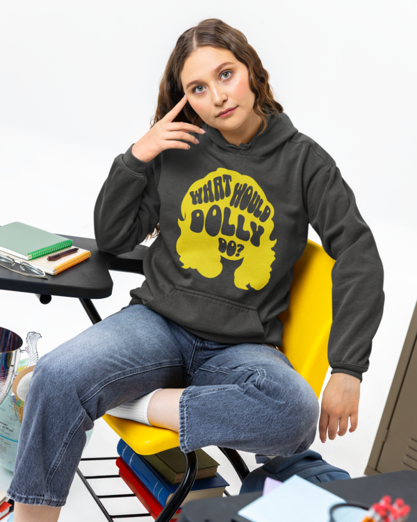 Person wearing a hoodie with a yellow graphic and text, sitting in a chair.