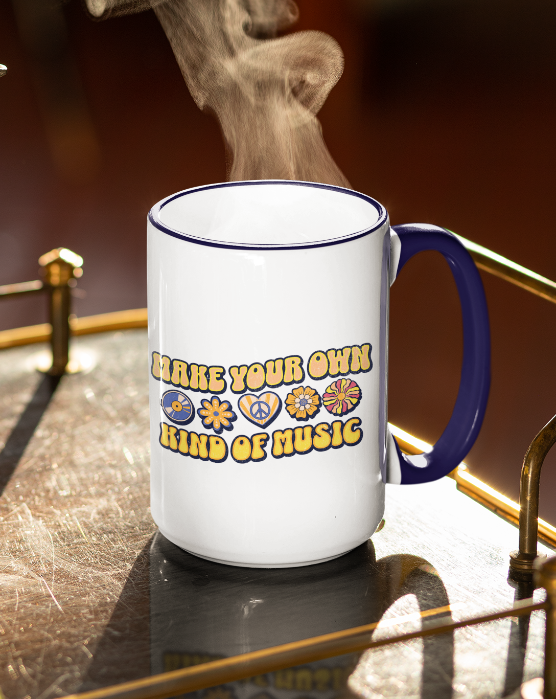 Steaming mug with 'Make your own kind of music' text on a reflective surface
