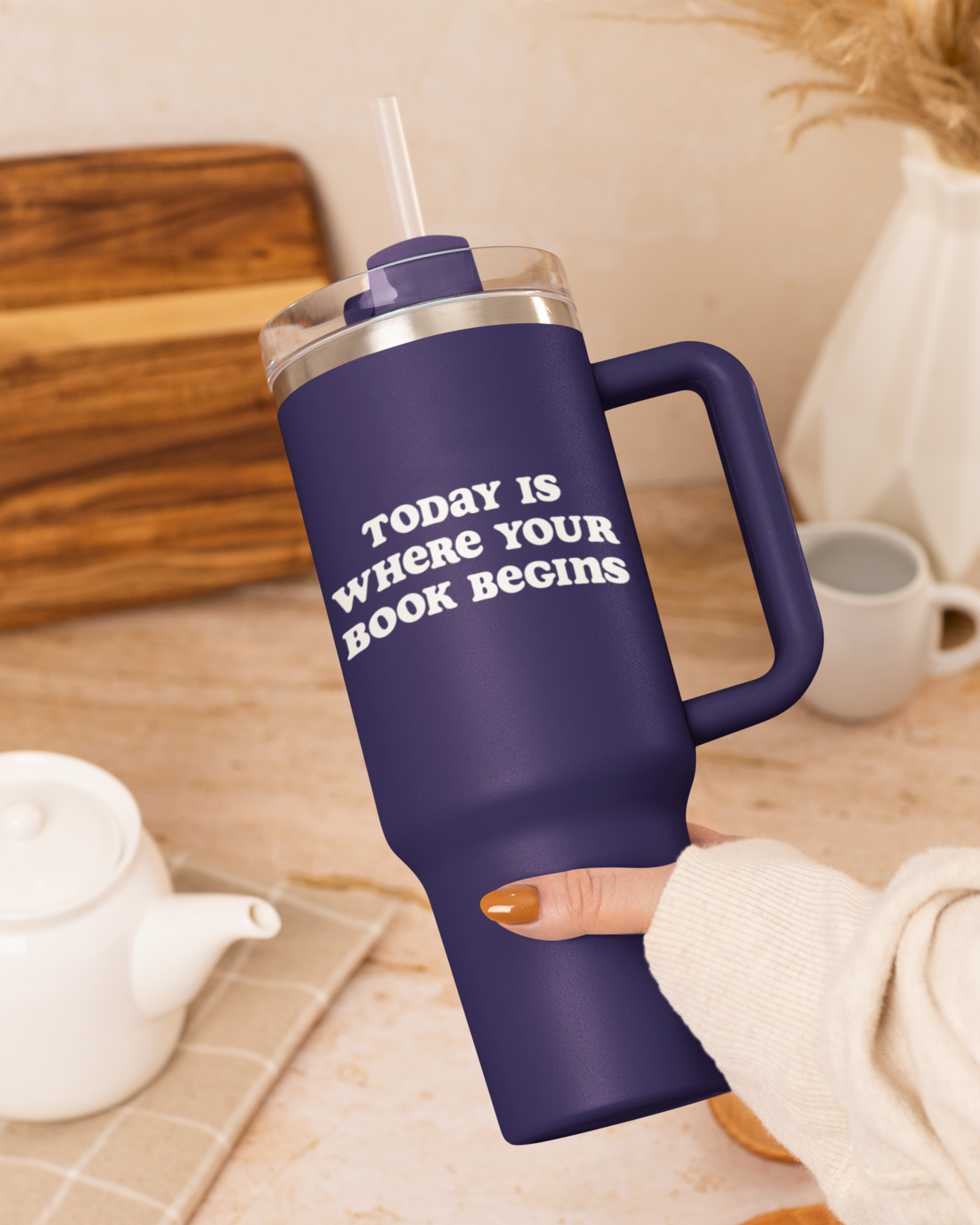 Navy blue mug with 'Today is where your book begins' text on a wooden surface.