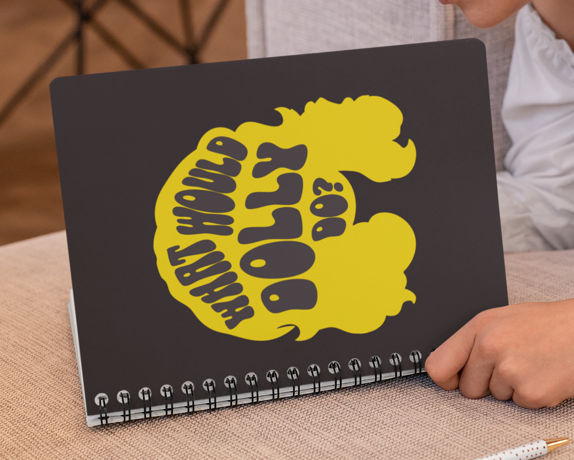 Person holding a notebook with a yellow logo on a couch